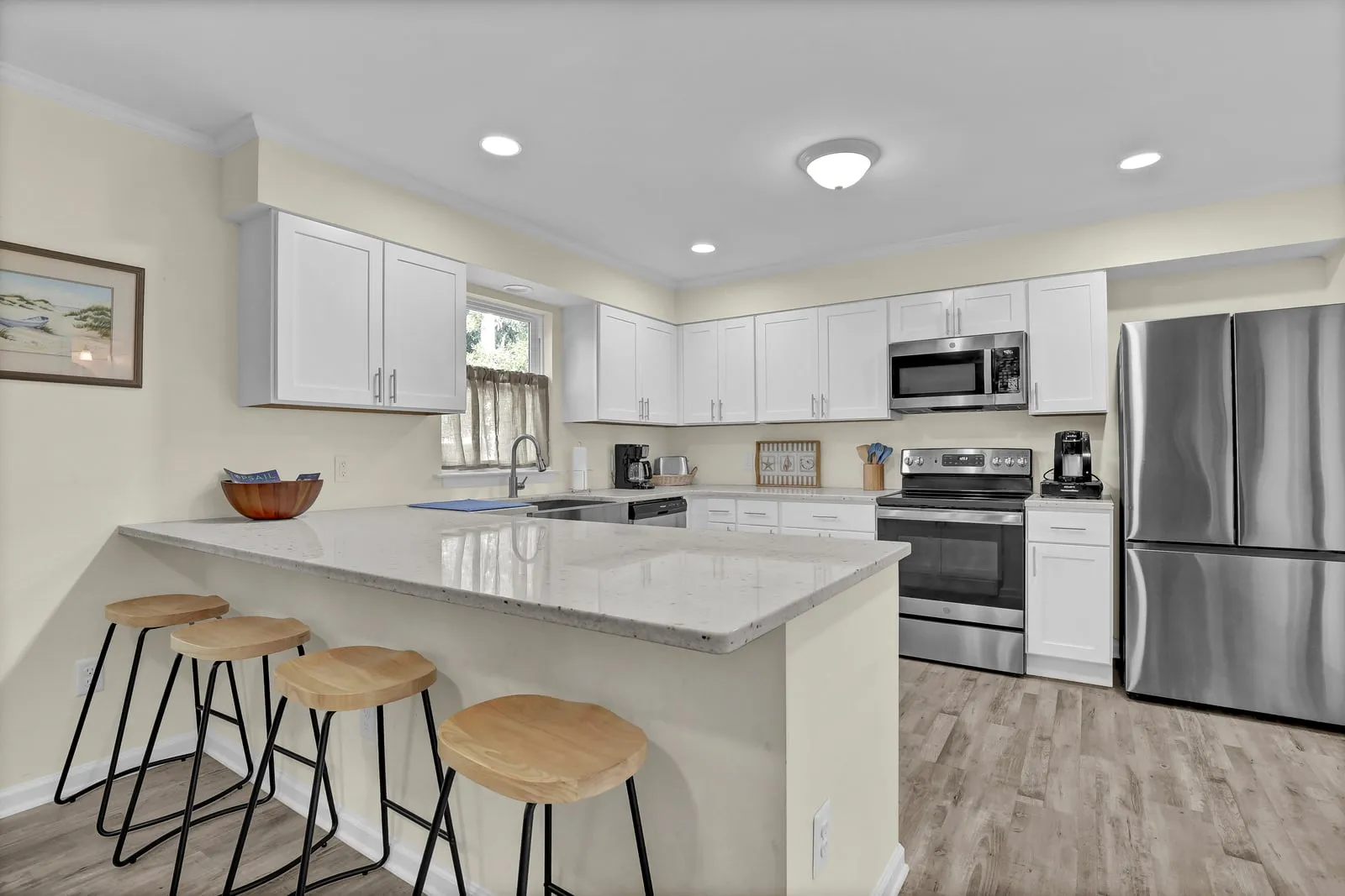 Fully stocked kitchen with island seating and bar stools
