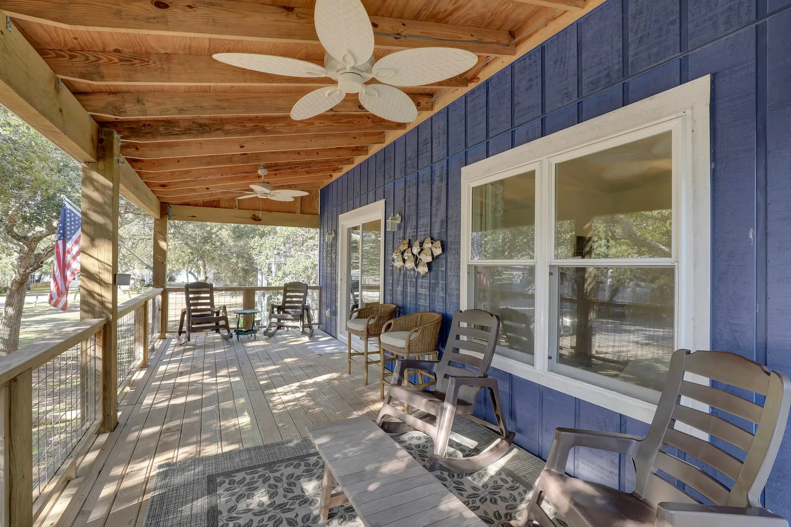 Covered front porch with ceiling fan where you can hear the ocean